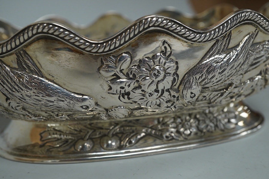 A late Victorian embossed silver oval bowl, decorated with birds, fruit and foliage, Charles Stuart Harris, London, 1889, length 14.3cm, 5.6oz.